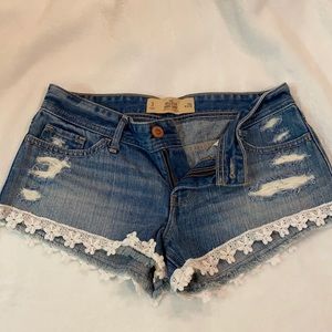 Lightly used Express jean shirt with floral trim